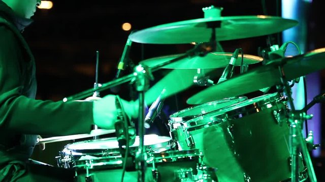 Beating Drums is a stunning stock video that shows footage of a drummer playing drums on stage. This 1920x1080 (HD) footage is ideal to use in any project that depicts drum, music and concert.