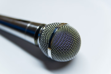 Silver audio microphone on white background