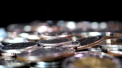 Slow motion close up falling coin on black background (Thai currency, THB coin)