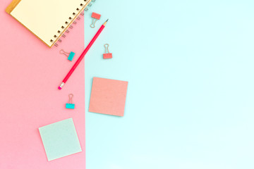School stationery on a pink and blue background. Back to school creative background, template. Creative, fashionable, minimalistic, office workspace with supplies on pink-blue background. Flat lay.