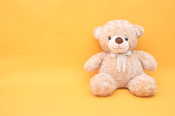 Teddy bear on yellow background