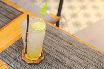 Lemonade with lemon slice. Iced lemon soda drink. In the restaurant with copy space.