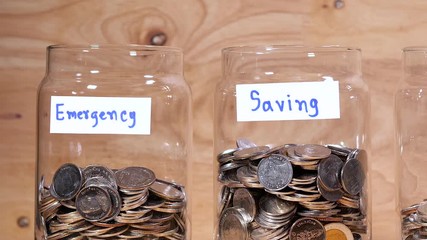 Close up save coin in the bottle glass on wood background (Thai currency, THB coin)