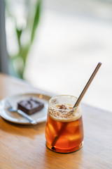 Sparkling Raspberry iced Americano on wooden background with natural window light.