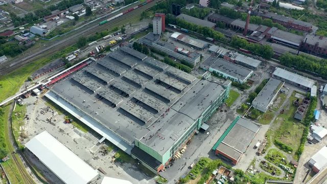 Aerial drone footage over small old soviet industrial zone garages factories facilities construction site near living quarters in Yekaterinburg, Russia