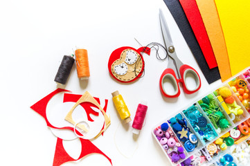Workshop devil felt toy. Red devil on a white background.