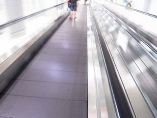 skywalk with blurred business people in airport
