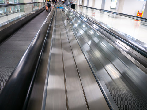 skywalk with blurred business people in airport