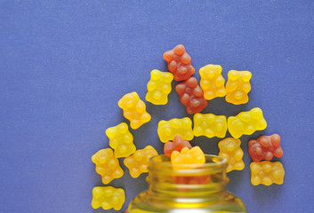 Gummy bear vitamin on colorful background.