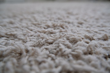 Closeup of a light carpet with thin threads