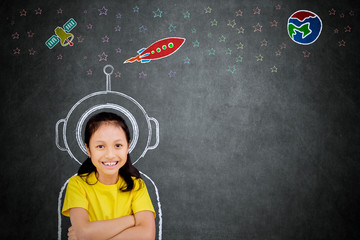 Female student imagining being an astronaut © Creativa Images