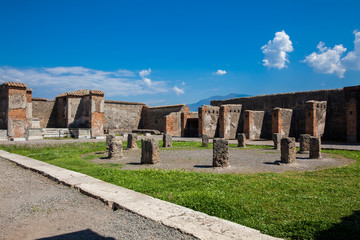 Fototapeta na wymiar Ruins of the Macellum in the ancient city of Pompeii in a beautiful early spring day