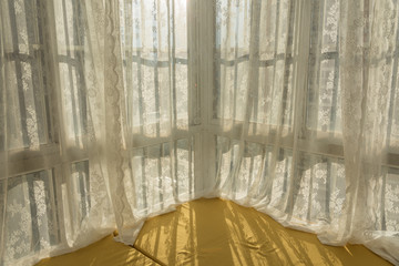 Backlight windowsill and white lace curtains in modern room