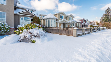 A typical american house in winter. Snow covered.