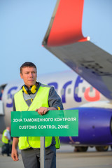 airport worker customs sign aircraft man male