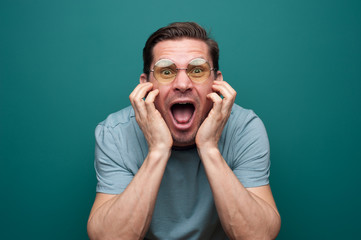 Portrait of an angry young man in glasses