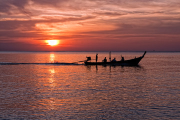 Fototapeta na wymiar Long tailed boat at sunset, Nai Yang beach, Phuket, Thailand