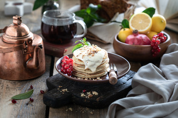 Sweet pancakes with currant berries and sauce