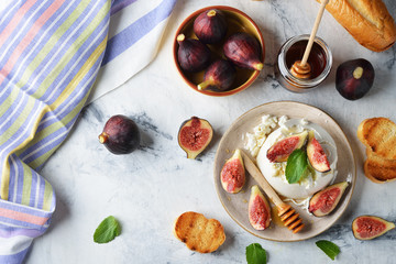 Ricotta cheese with honey and figs on a white background