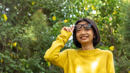Happy asia girl wear glasses at the garden.