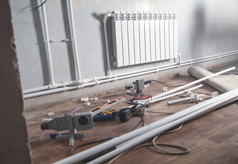 Connecting plastic pipe. Installing water heating radiator