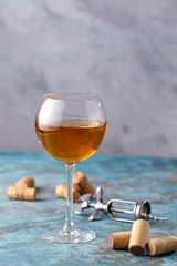 White wine in a glass. The concept of winemaking. Place under your text. Still life on a textural background.