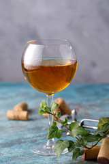 White wine in a glass. The concept of winemaking. Place under your text. Still life on a textural background.