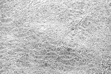 Shiny silver leaf gray foil texture background.