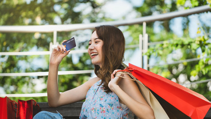 Asian young woman shopping pay with credit card.