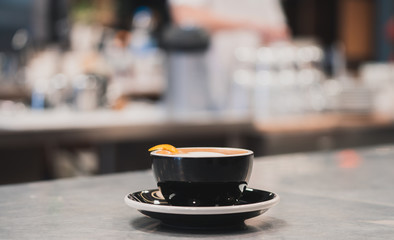 Soft focus coffee cup on stainless table