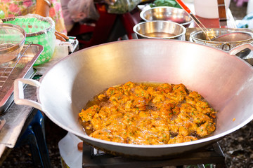Deep fried thai style fish cake in big pan at the market in Thailand, fried spicy fish cake, thai snack