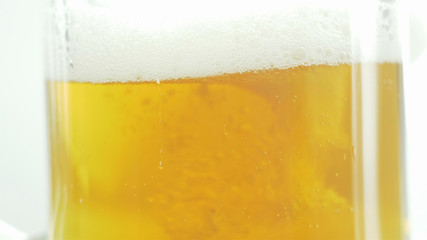 craft beer is poured into a glass on an isolated background
