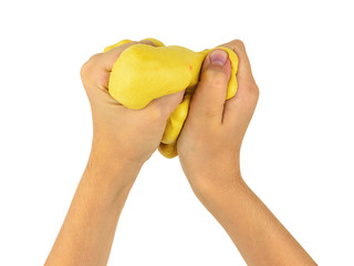 The child's hands knead the yellow slime isolated on a white background.