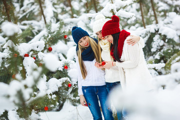 Women on Christmas background. Young girls hawing fun in winter time