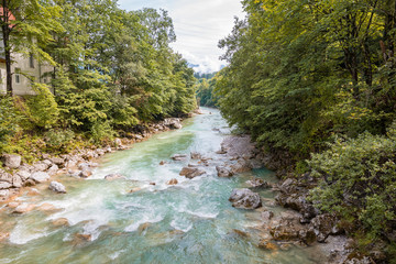 Emerald to turquoise colored water of the river "Branderberger Ache" near the town of Kramsach in Tirol, Austria