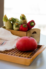 Composition of fresh ripe zucchini with hot red chili peppers and tomato on kitchen table