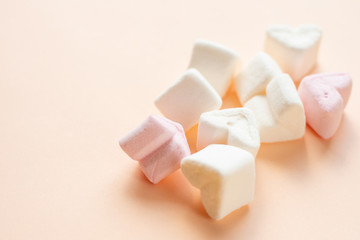 Marshmallows in the shape of pink and white hearts. Flat layout.