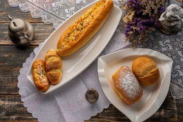 resh bread on wooden table. Top view with space for your text