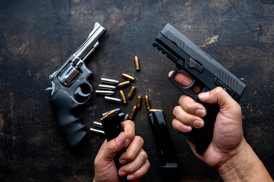 Hand guns , ammo ,Guns with ammunition on Dark background. 