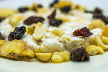 Close-up, macro shot of rice waffles and dried fruit (banana, peanut, pineapples, cashews etc.) Healthy food and health care concept.