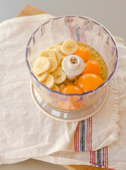 Blender bowl with eggs and banana slices with cereals, eating healthy concept