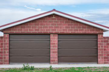 Brick garage with roller shutters for two cars