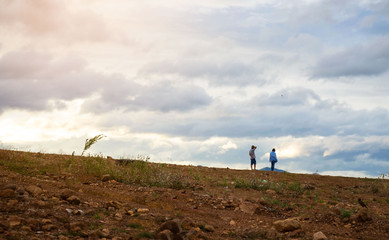 Fototapeta premium landscape at evening time man and woman standing sky background .