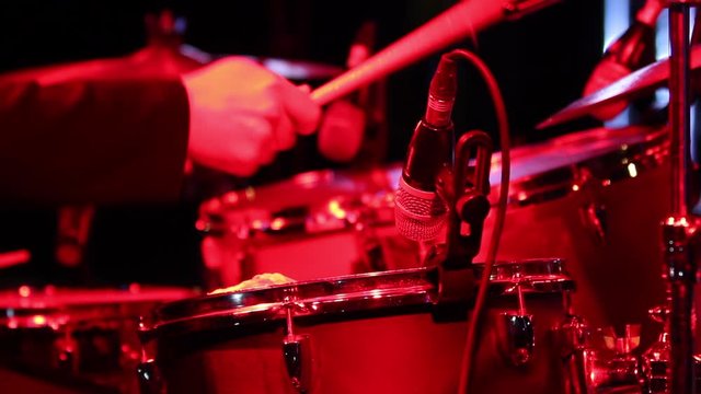 Beating Drums is a stunning stock video that shows footage of a drummer playing drums on stage. This 1920x1080 (HD) footage is ideal to use in any project that depicts drum, music and concert.