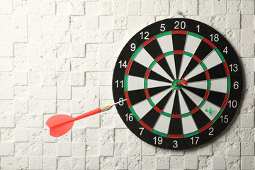 Color darts and board on textured background
