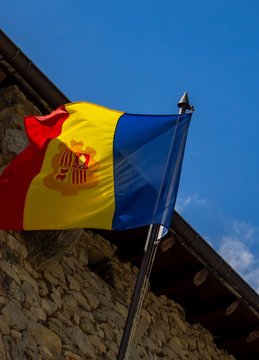 Flag of Andorra on the flagpole on The Casa de la Vall at Andorra La Vella.
