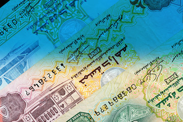 Fototapeta na wymiar UAE dirham currency notes close up. Money background blue color toned