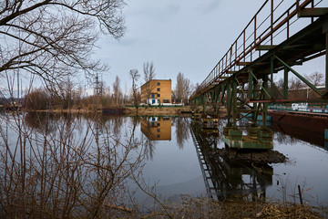 The abandoned river port in Pripyat. Abandoned ships in the river near of Chernobyl. Modern ruins....