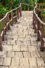old wooden bridge over a stream, vertical photo