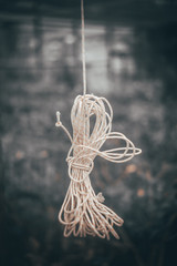 coiled rope hanging behind glass, background, selective focus, film and grain photo